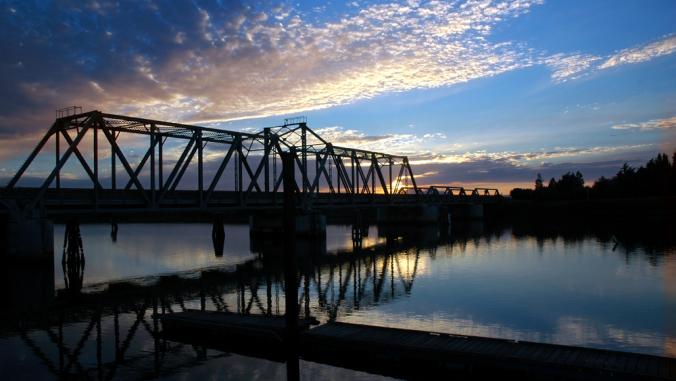 Trestle bridge at sunset over the San Joaquin River in Central Valley, California.