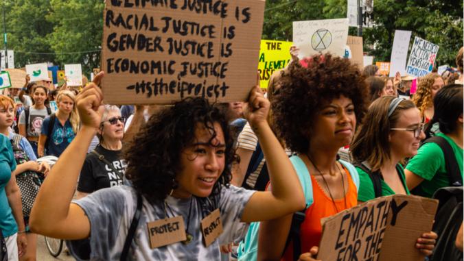 Thousands of teens and people march in downtown Chicago to bring awareness to the urgency of climate change.