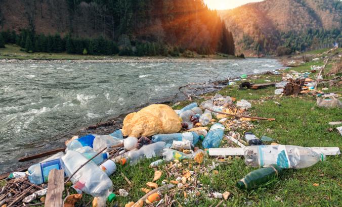 Plastic garbage on a mountain river bank