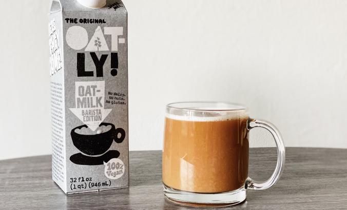 Oatly milk next to coffee