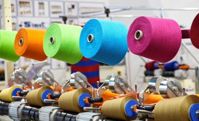Textile fibers on roles in factory Milan
