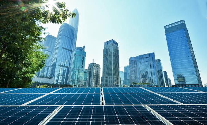 Solar panels with city behind