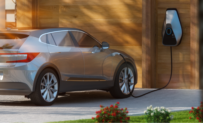 Electric SUV parked and charging in front of a home