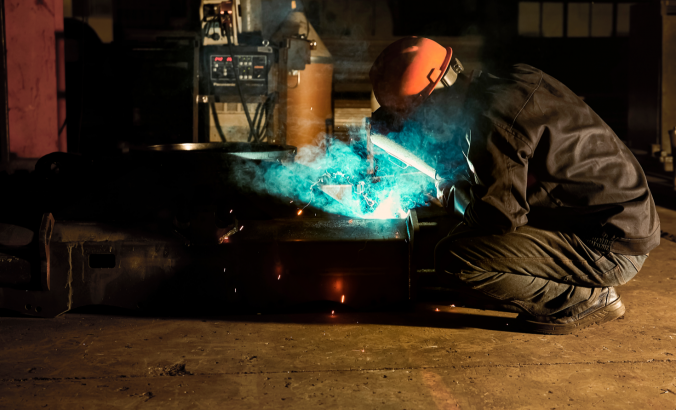 Electric welder is working with iron