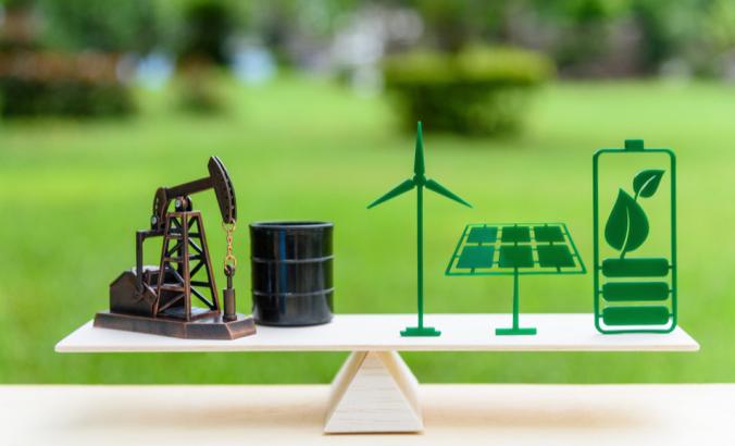 Petroleum pumpjack, crude oil drum barrel, solar panel, green leaf battery, wind turbine on a wood balance scale in equal position.