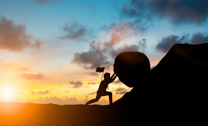 Person pushing boulder up a hill