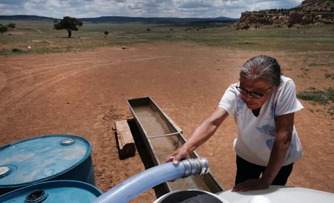 Women looks at a water pump