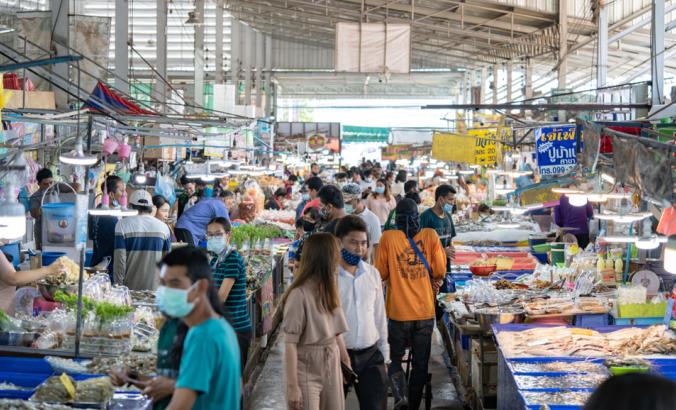 Local People walk and shop seafood at the Angsila fish market, the large fresh market in Chonburi Province, Thailand.