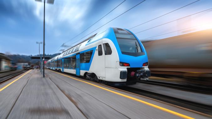 A blue high-speed train in motion.