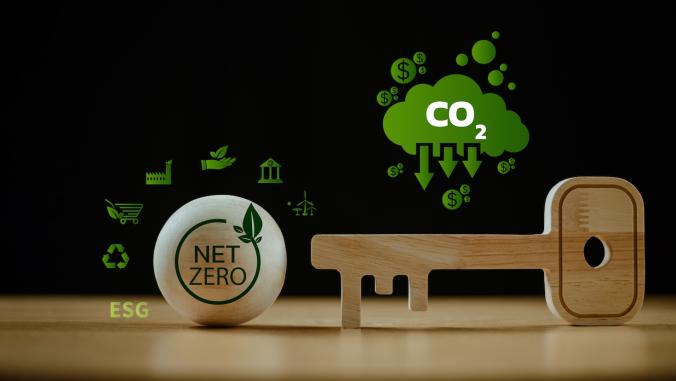 Wooden key unlocks net zero target icon, accompanied by carbon reduction icon 